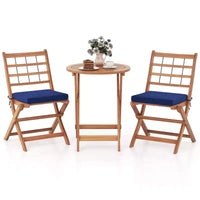 Ensemble de bistro Costway 3 pièces en bois d'acacia pour patio, table et chaises pliantes d'extérieur avec coussins, blanc cassé/bleu marine/gris
