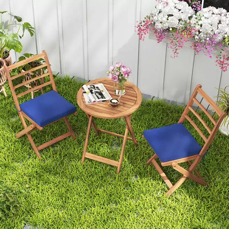 Ensemble de bistro Costway 3 pièces en bois d'acacia pour patio, table et chaises pliantes d'extérieur avec coussins, blanc cassé/bleu marine/gris