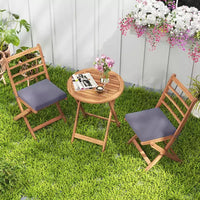 Ensemble de bistro Costway 3 pièces en bois d'acacia pour patio, table et chaises pliantes d'extérieur avec coussins, blanc cassé/bleu marine/gris