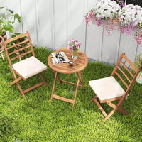 Ensemble de bistro Costway 3 pièces en bois d'acacia pour patio, table et chaises pliantes d'extérieur avec coussins, blanc cassé/bleu marine/gris